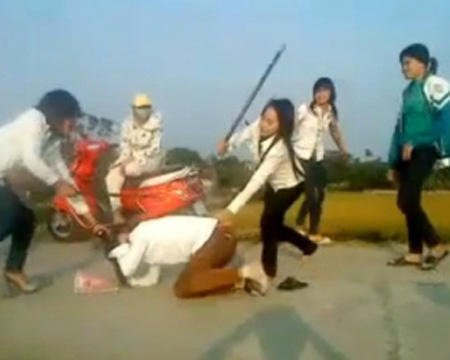 Ảnh cắt từ video clip “Nữ sinh múa gậy trên lưng bạn”