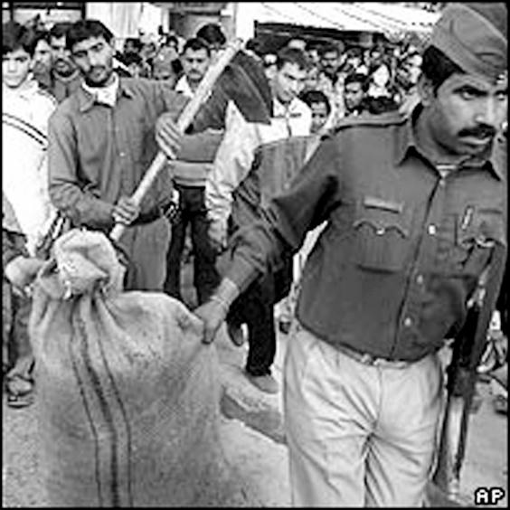 Cảnh sát mang đi những bao tải đựng những phần thi thể bị cắt rời.