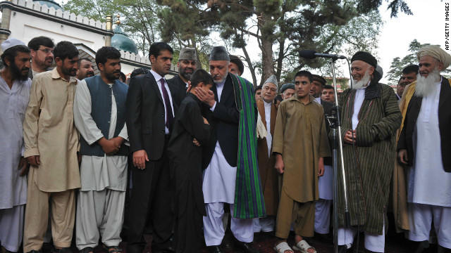 Tổng thống Karzai và một đứa trẻ từng được giải cứu. Ảnh: CNN