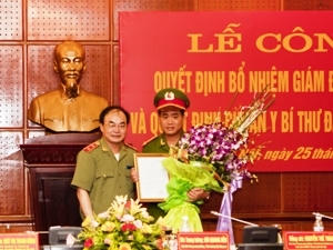 Trung tướng Bùi Quang Bền trao quyết định và tặng hoa chúc mừng Đại tá Nguyễn Đức Chung - Tân Giám đốc CATP Hà Nội (Ảnh: Sơn Bách/Vietnam+)