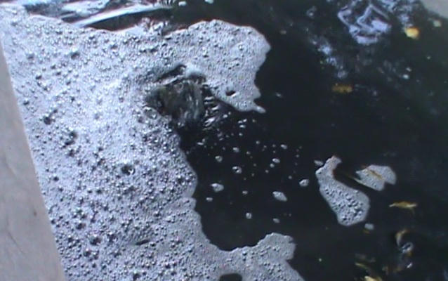 Nước trộn với xăng dầu phun lên từ cống thoát nước