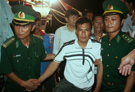 Ngư dân Trung Quốc không may gặp nạn Trịnh Tổ Ba (áo trắng, ở giữa) được lực lượng BĐBP Quảng Bình đưa lên bờ vào đất liền.
