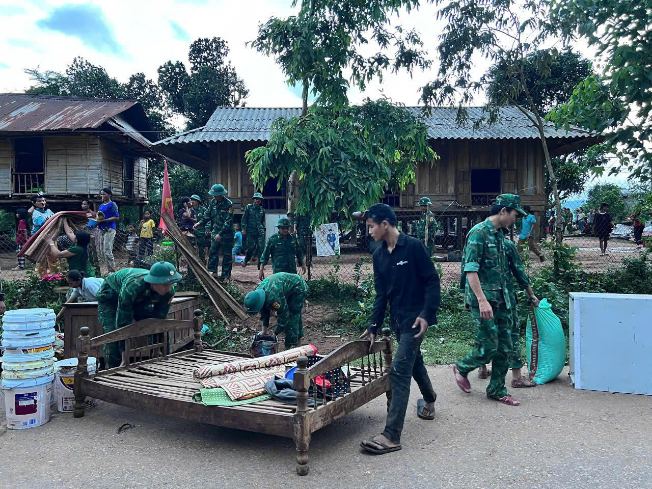 Cán bộ chiến sĩ Đồn Biên phòng Ba Tầng phối hợp với chính quyền địa phương khắc phục, hỗ trợ, giúp gia đình anh Roi tạm thời ổn định cuộc sống.