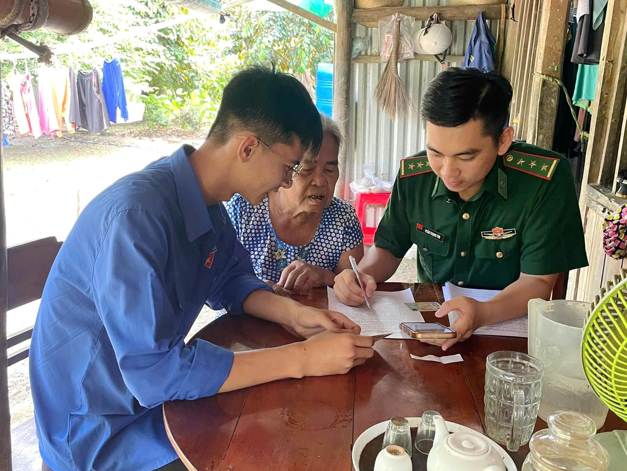 Cán bộ, chiến sĩ BĐBP tỉnh Cà Mau đến tận nhà hỗ trợ người dân thực hiện thủ tục hành chính công.