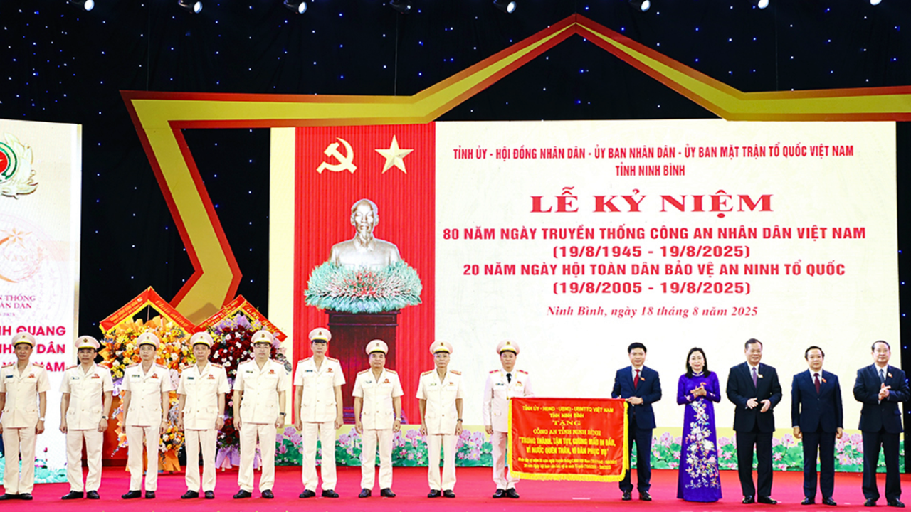 Lãnh đạo tỉnh Ninh Bình trao tặng bức trướng của Tỉnh ủy, HĐND, UBND, Ủy ban MTTQ Việt Nam tỉnh Ninh Bình cho lực lượng Công an tỉnh Ninh Bình (Ảnh: Trần Ích)