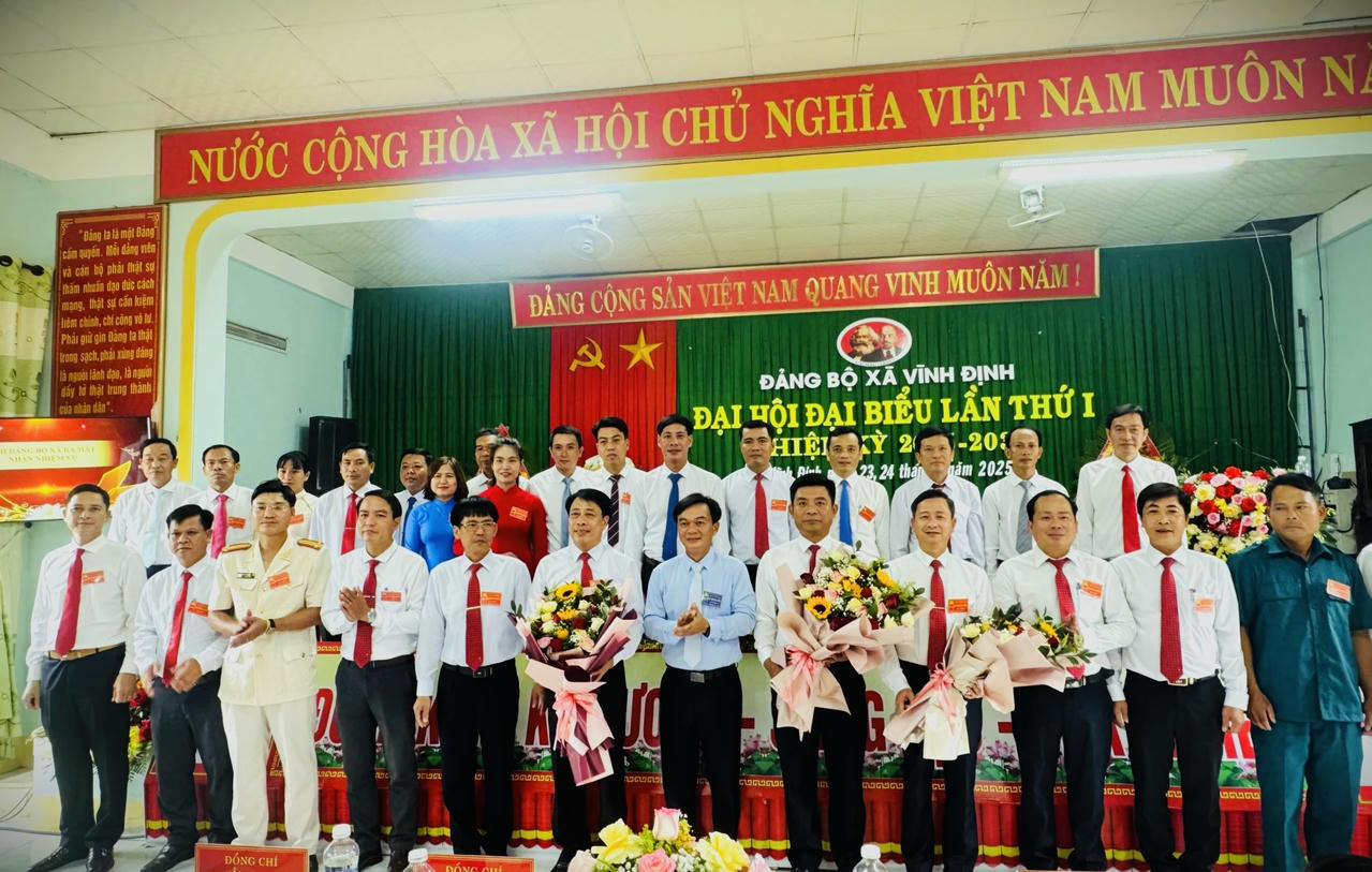 Phó Chủ tịch Thường trực HĐND tỉnh Nguyễn Chiến Thắng tặng hoa chúc mừng Ban Chấp hành Đảng bộ xã Vĩnh Định nhiệm kỳ mới.
