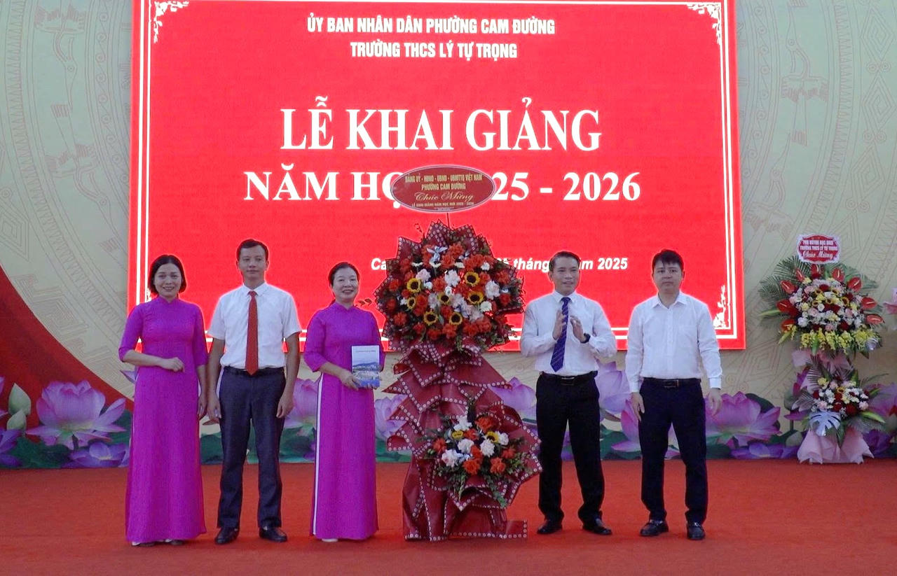 Ông Nguyễn Xuân Nhẫn, Chủ tịch UBND phường Cam Đường tặng hoa chúc mừng