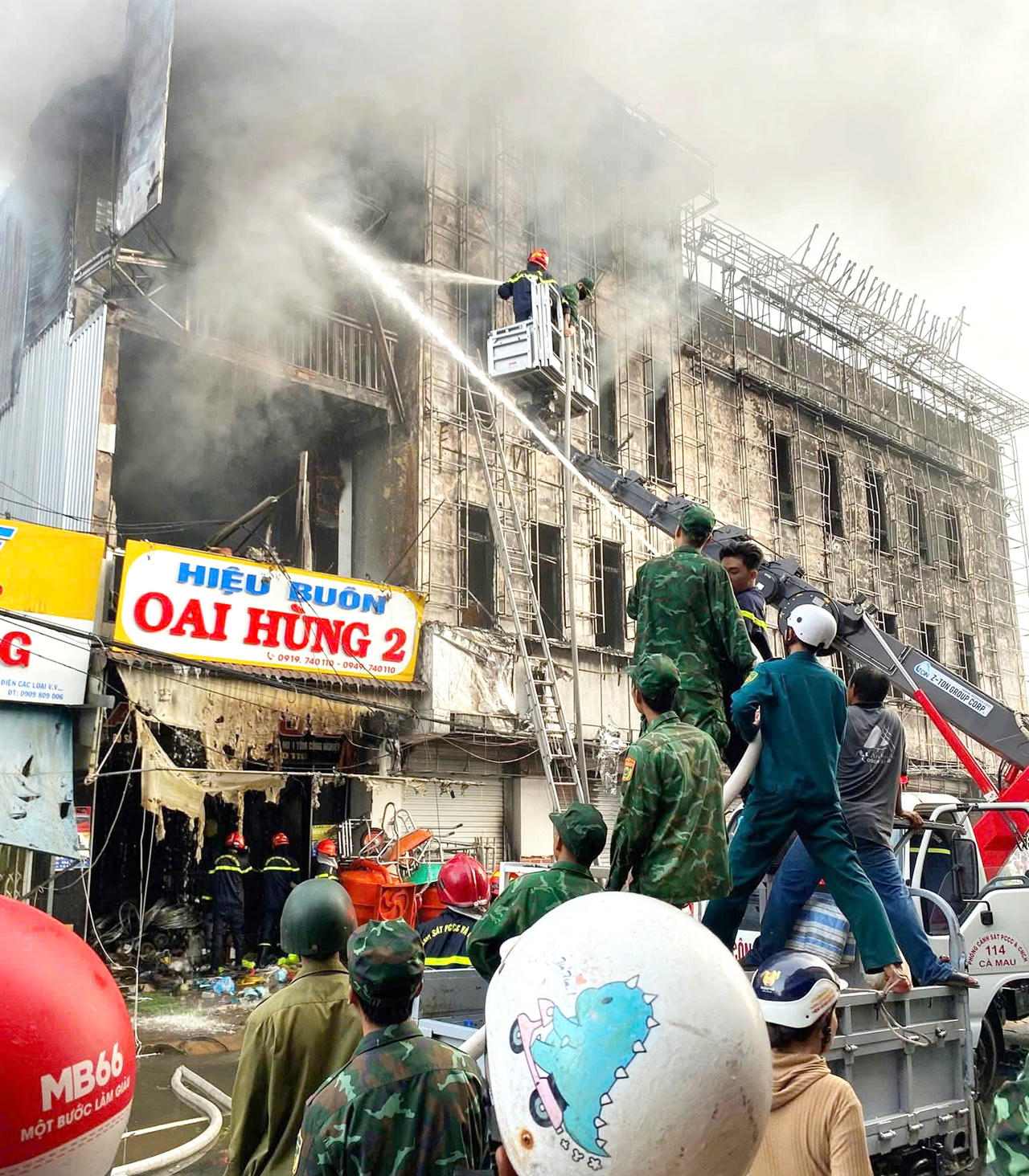 Cán bộ, chiến sĩ Đồn Biên phòng CKC Năm Căn phối hợp các lực lượng tham gia chữa cháy.