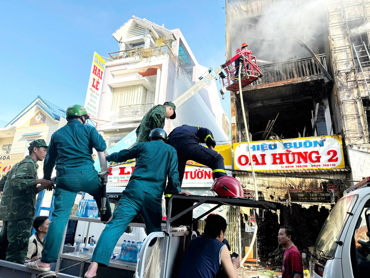 Các lực lượng phối hợp cùng người dân khắc phục hậu quả vụ cháy.