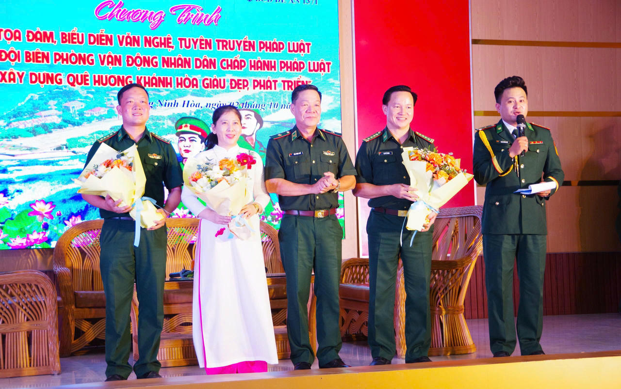 Thiếu tướng Văn Ngọc Quế - Phó Chủ nhiệm Chính trị, Bộ Tư lệnh BĐBP tặng hoa các đại biểu dự tọa đàm.