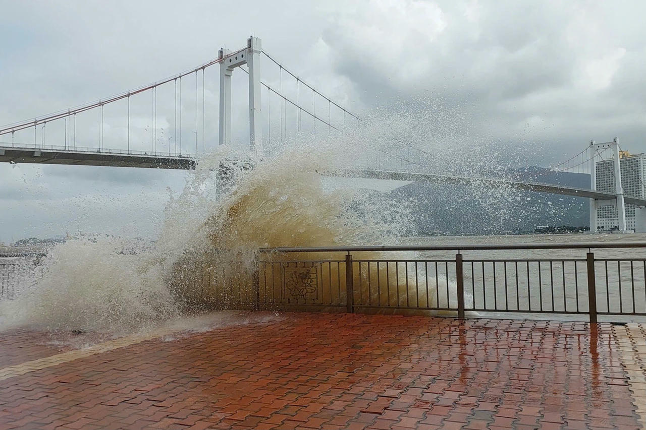 Sóng lớn kết hợp triều cường tràn bờ cửa sông Hàn, nước tung thành cột vượt lan can rồi tràn ra lòng đường Như Nguyệt.