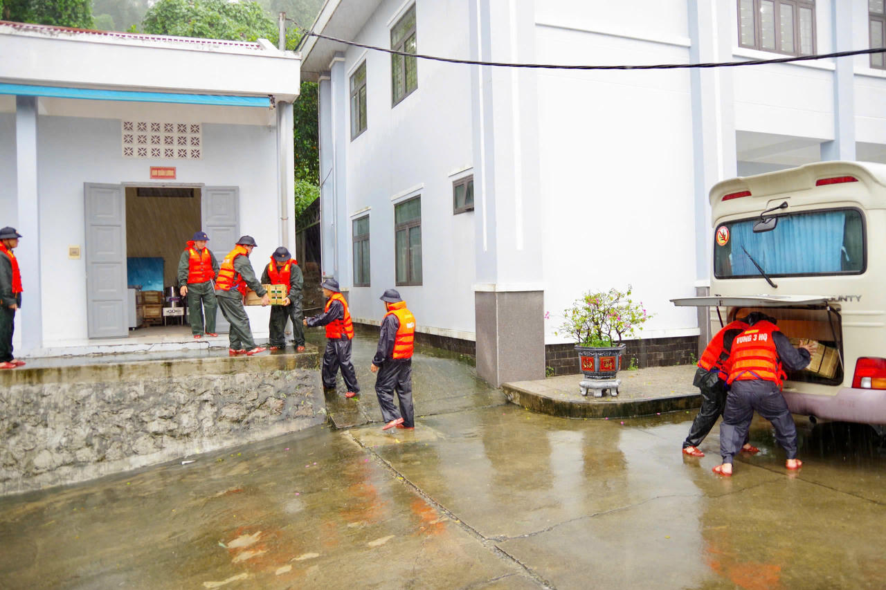 Lực lượng cứu trợ đang trung chuyển hàng hóa, nhu yếu phẩm, bàn giao cho tổ trưởng tổ dân phố tiếp tục đưa đến từng hộ gia đình ở khu vực trọng điểm