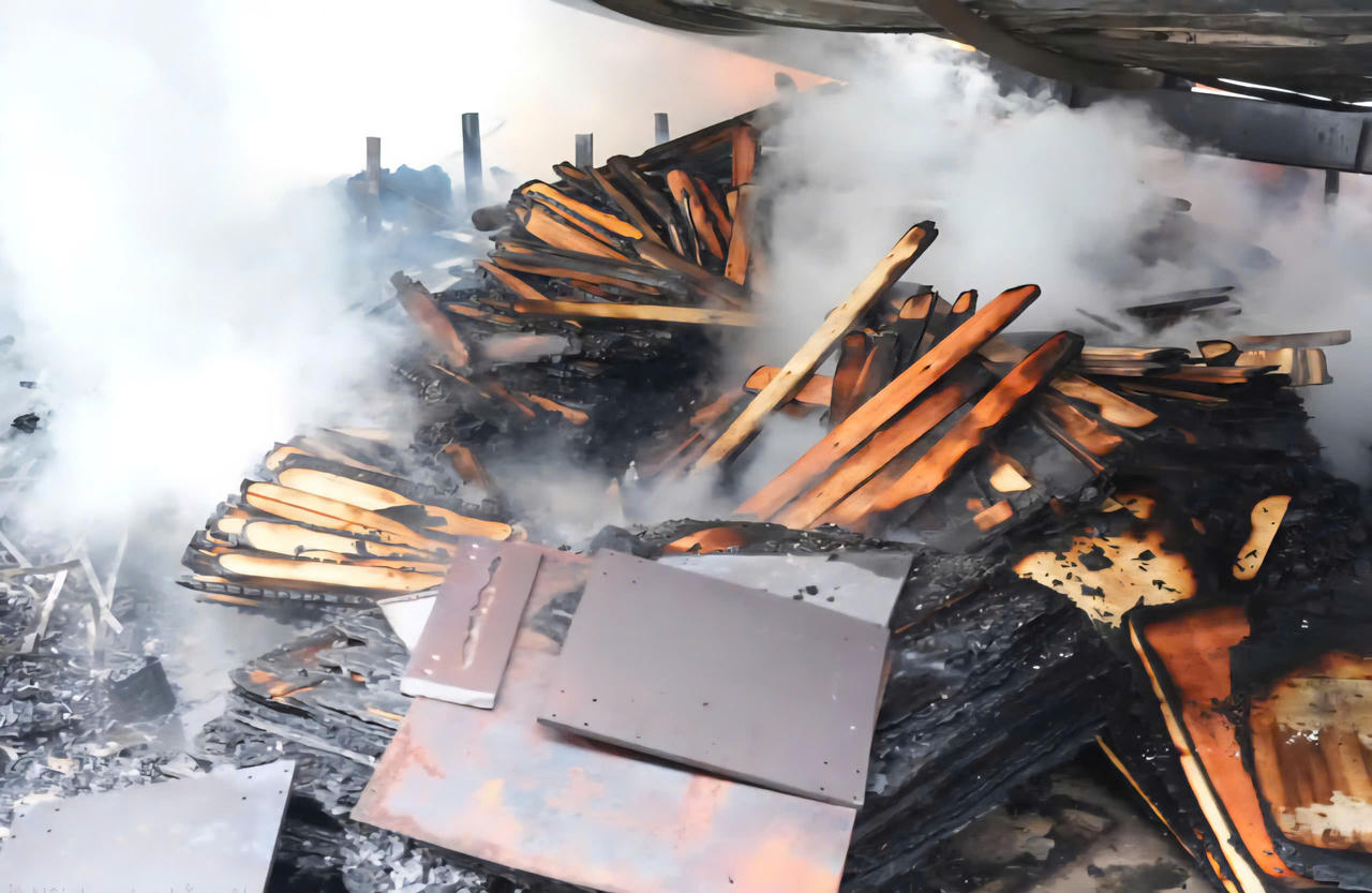 Nhiều vật liệu gỗ và pallet đã bị thiêu rụi bên trong xưởng.