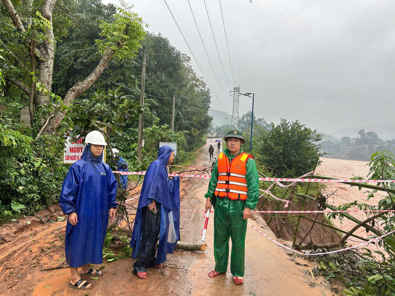Mưa lớn liên tục khiến nhiều tuyến đường bị sạt lở, lực lượng chức năng phải cắt cử người ứng trực đê đảm bảo an toàn.
