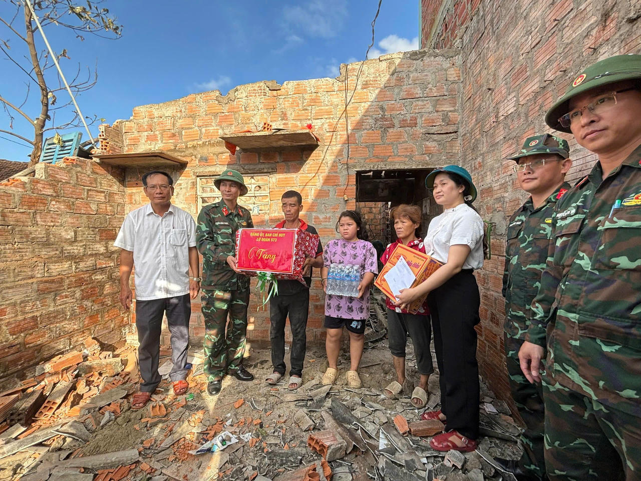 Đại diện Lữ đoàn 573 và Đảng ủy xã Tuy Phước Bắc trao quà hỗ trợ cho một hộ gia đình chính sách bị thiệt hại nặng.