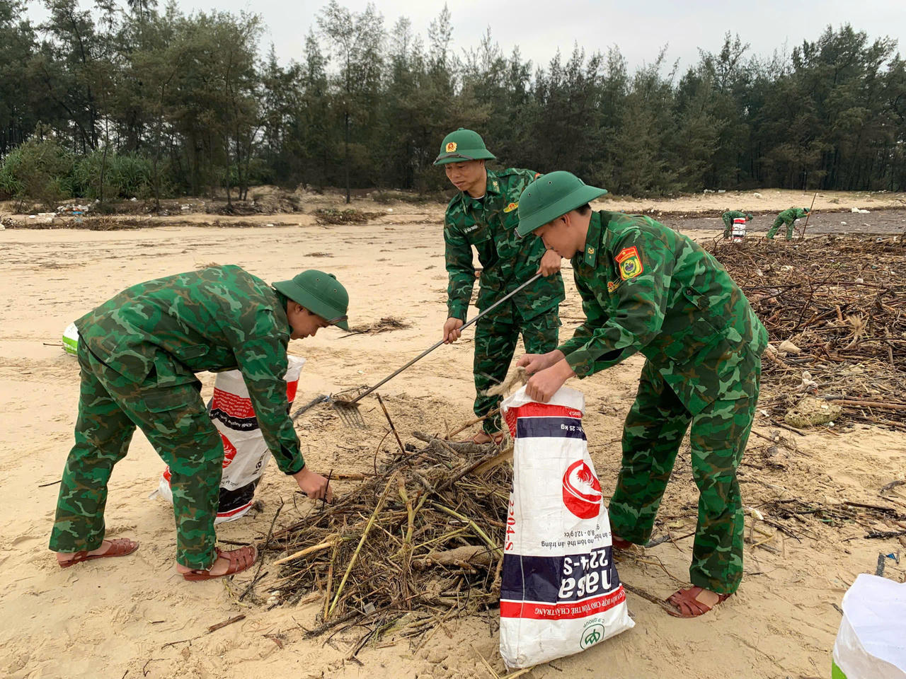 Màu áo xanh tình nguyện làm sạch môi trường biển sau mưa lũ.