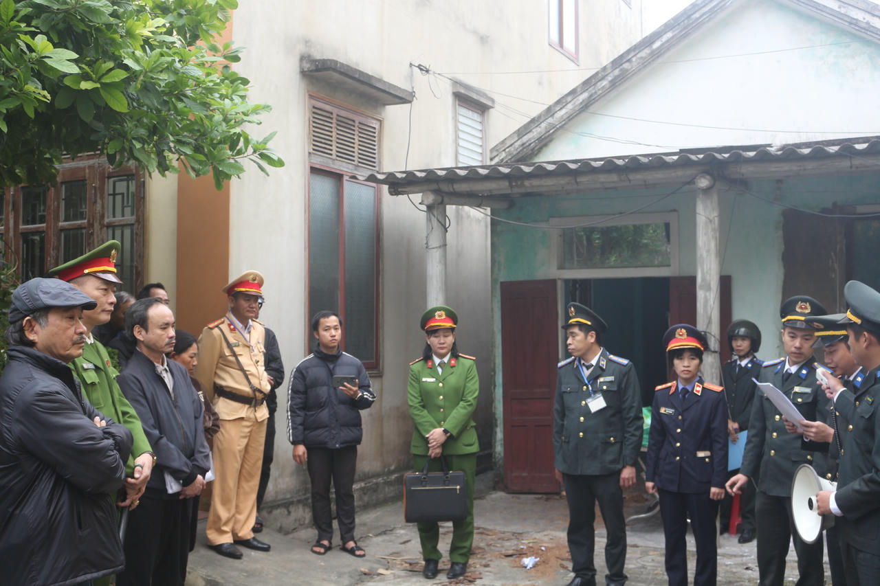 Chấp hành viên công bố Quyết định cưỡng chế thi hành án trước sự chứng kiến của các lực lượng chức năng.