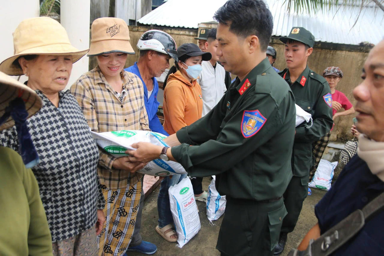 Cán bộ chiến sĩ Đội Đặc nhiệm E23 hỗ trợ vận chuyển và trao quà cho người dân phường Quy Nhơn Tây.
