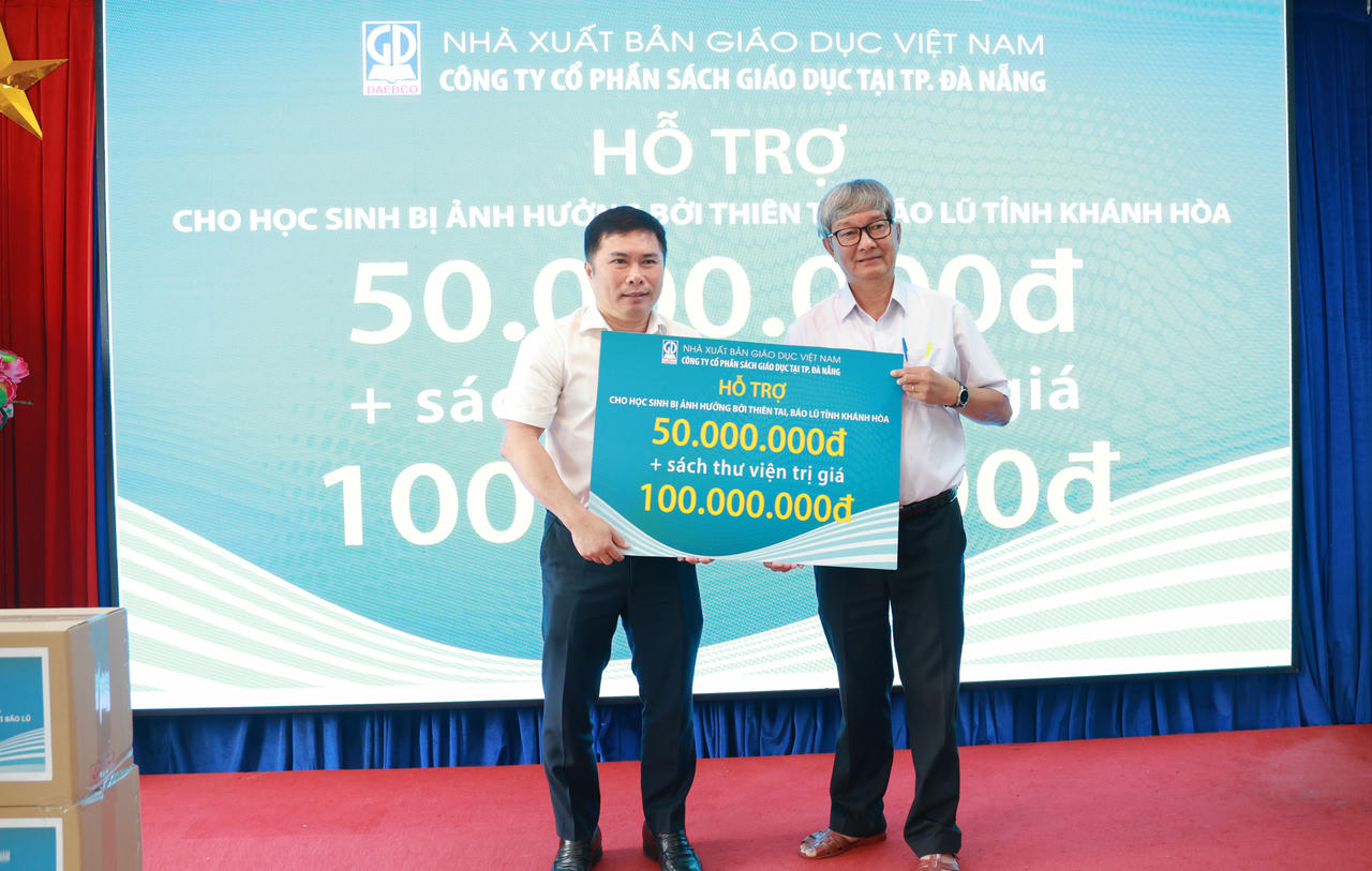 Ông  Lý Xuân Hoàn – Giám đốc Công ty CP Sách giáo dục tại TP. Đà Nẵng trao biển hỗ trợ tiền và sách tham khảo dùng cho thư viện trường học cho đại diện Sở GD- ĐT tỉnh Khánh Hòa