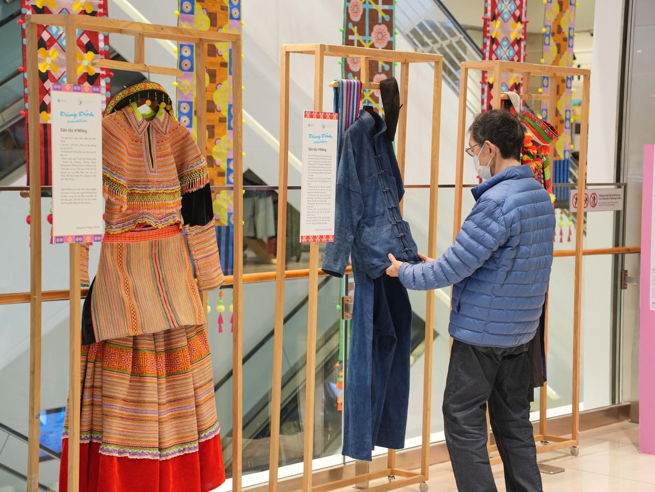 A person wearing a mask and holding a pair of clothesAI-generated content may be incorrect.