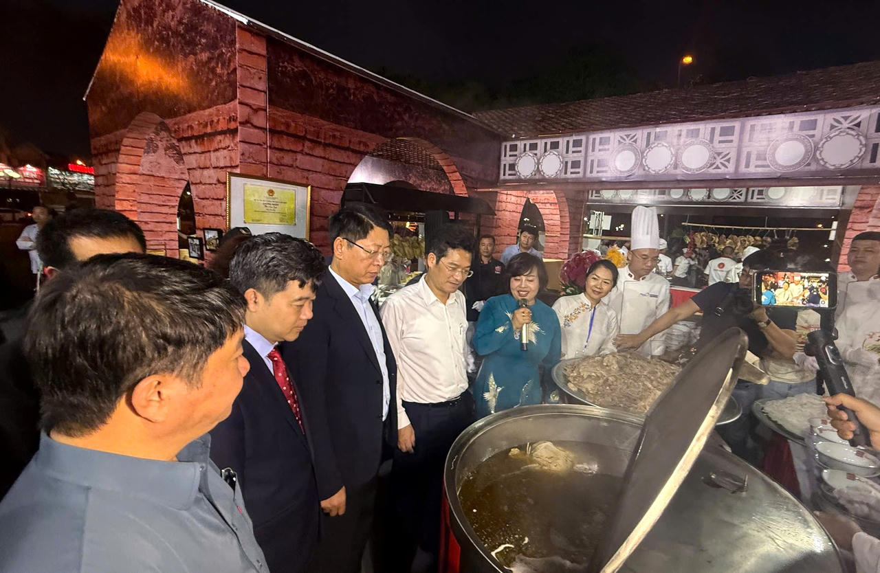 Bà Lê Thị Thiết - Chủ tịch Hiệp hội văn hóa ẩm thực tỉnh Ninh Bình đang giới thiệu với Phó chủ tịch UBND tỉnh Trần Song Tùng và cùng các đại biểu cách chế biến món Phở