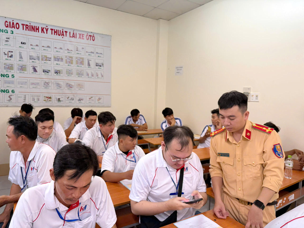 Cán bộ Cảnh sát giao thông hỗ trợ người dân cài đặt, sử dụng ứng dụng VNeTraffic.