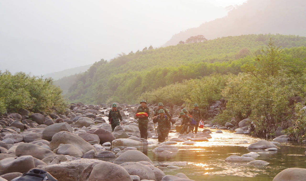 Lực lượng Đội Quy tập 589 (Bộ CHQS tỉnh Quảng Trị) vượt suối, băng rừng đưa hài cốt liệt sĩ tại bản Bãi Dinh (xã Dân Hóa) về quy tập.