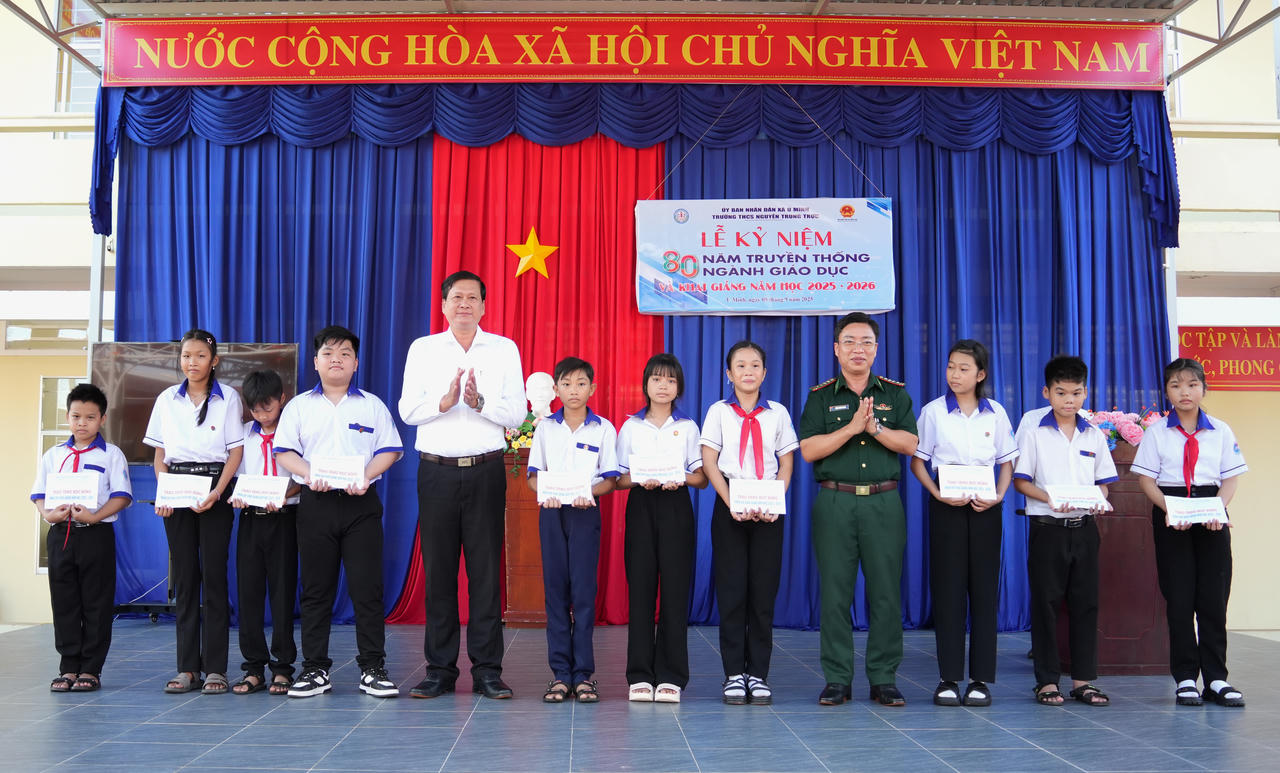 Đại tá Phạm Minh Giang - Bí thư Đảng ủy, Chính ủy Ban Chỉ huy BĐBP tỉnh Cà Mau cùng lãnh đạo xã U Minh trao học bổng cho học sinh Trường THCS Nguyễn Trung Trực.