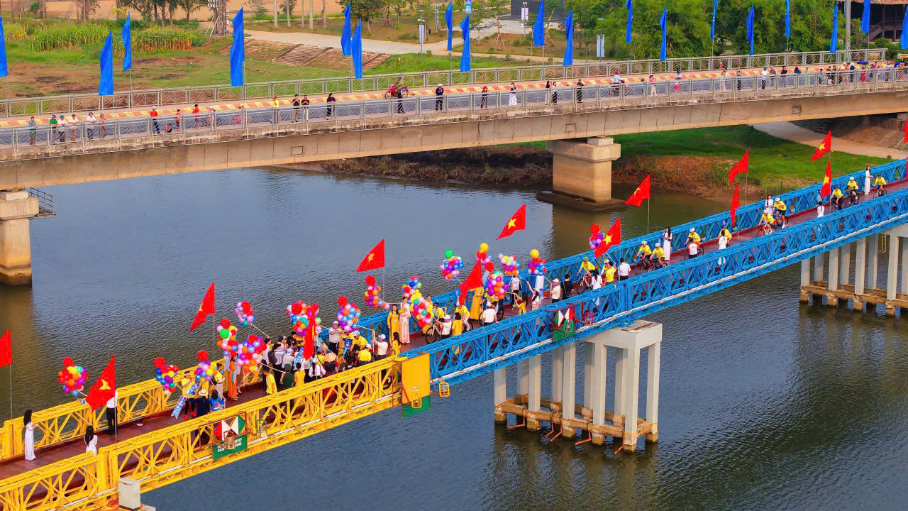 Đoàn vận động viên diễu hành đạp xe qua cầu Hiền Lương, biểu tượng của khát vọng hòa bình và thống nhất.