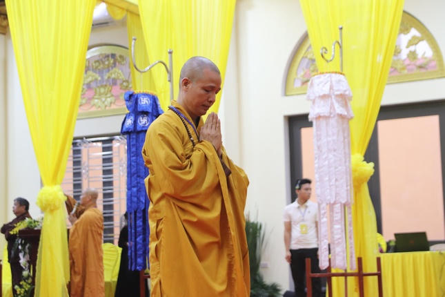 Một nhà sư thành kính vái lạy trước kim quan Trưởng lão Hòa thượng, bày tỏ lòng tri ân và niềm tiếc thương sâu sắc.