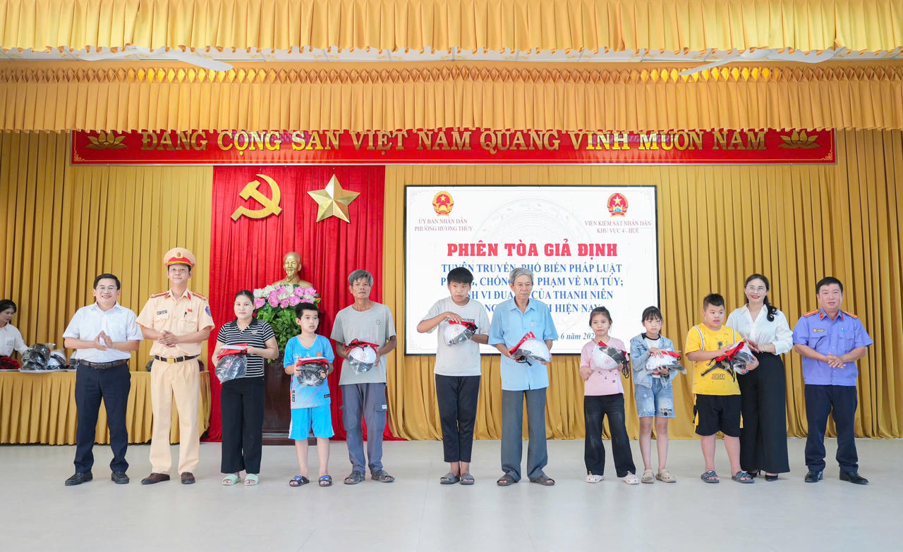 Thiếu tá Dương Văn, Đội trưởng Đội Cảnh sát giao thông đường bộ số 2, Phòng CSGT Công an TP Huế; bà Ngô Thị Lệ Thủy, Chủ tịch Ủy ban MTTQ Việt Nam phường; ông Nguyễn Quang Bình, Phó Chủ tịch UBND phường Hương Thủy và ông Nguyễn Hữu Lành, Phó Viện trưởng Viện KSND khu vực 4 - Huế&nbsp;trao quà cho các em học sinh có hoàn cảnh khó khăn.