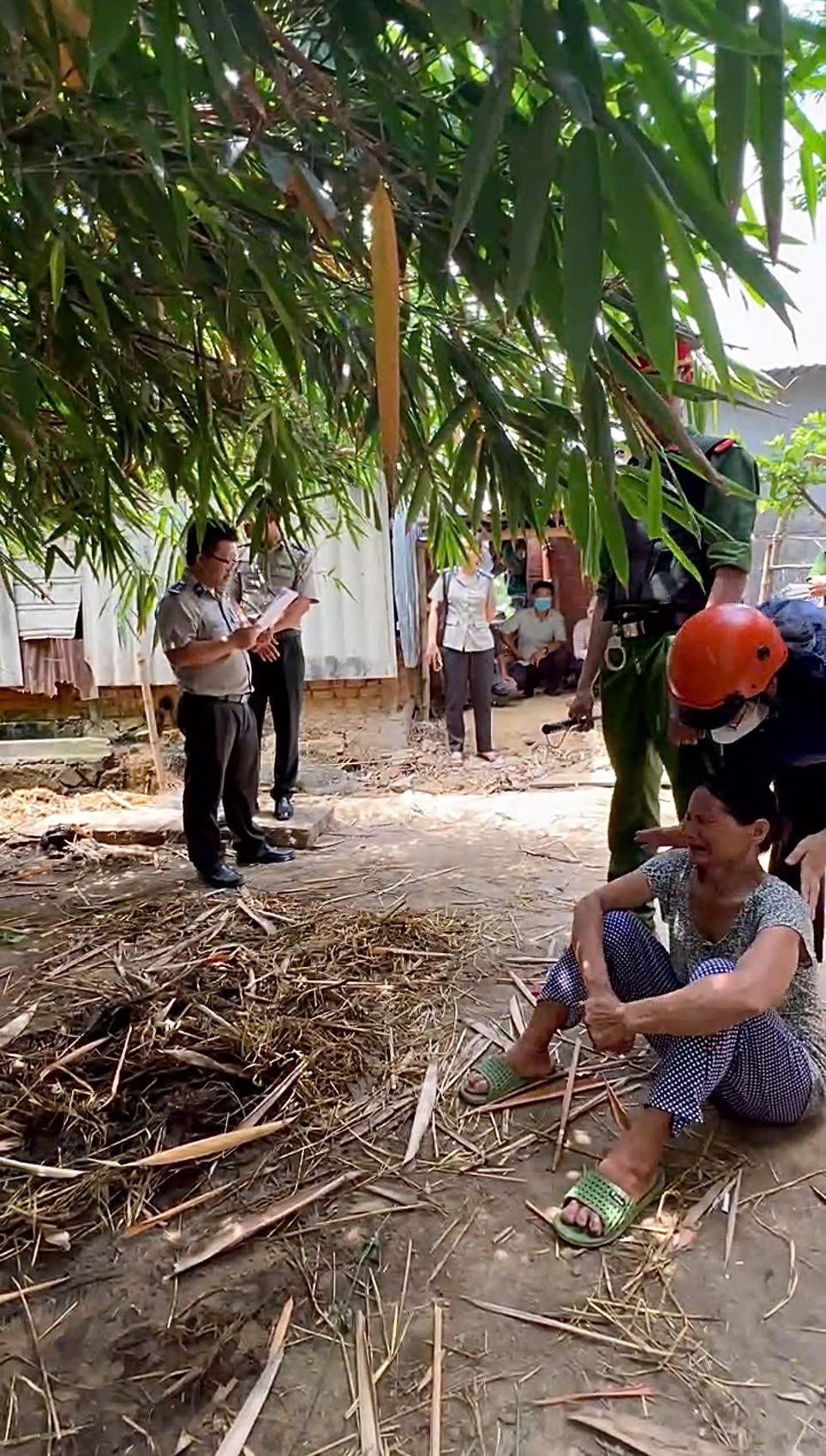 Bà Năm sau khi đã ổn định tâm lý, bình tĩnh ngồi nghe thông cán bộ THA thông qua biên bản cưỡng chế.