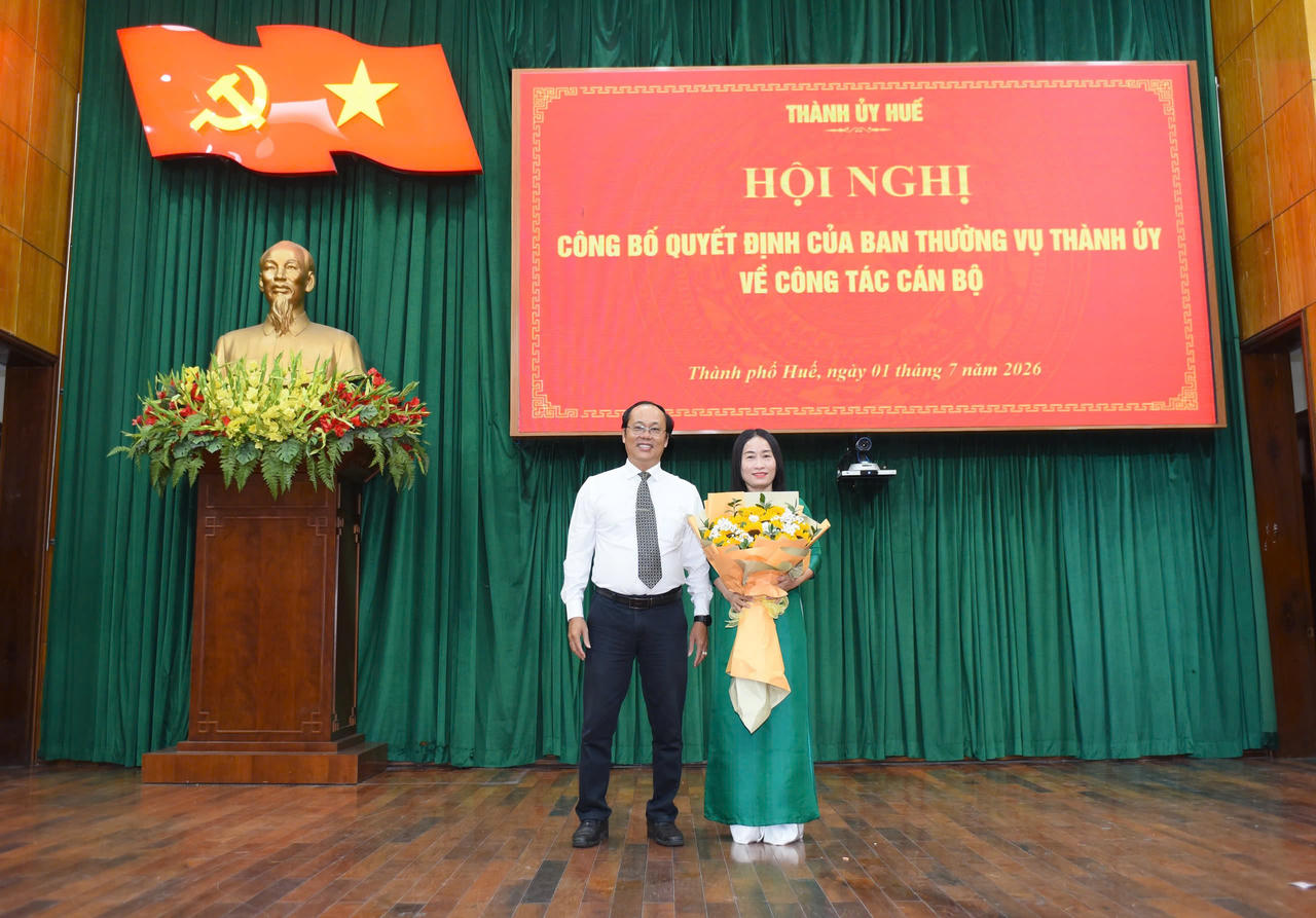 Bà Châu nhận hoa chúc mừng từ ông Hoàng Đăng Khoa (Tân Hiệu trưởng Trường Chính trị Nguyễn Chí Thanh)