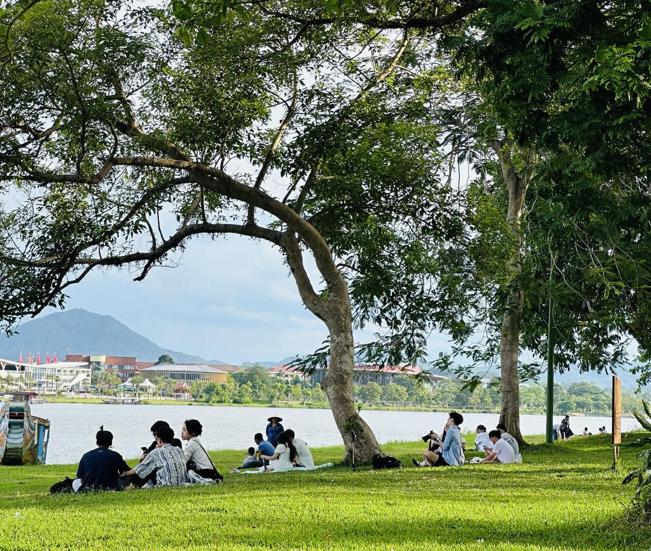 Thảm cỏ xanh mướt cùng hệ thống cây xanh ven sông Hương tạo nên không gian trong lành, mát mẻ giữa những ngày hè.