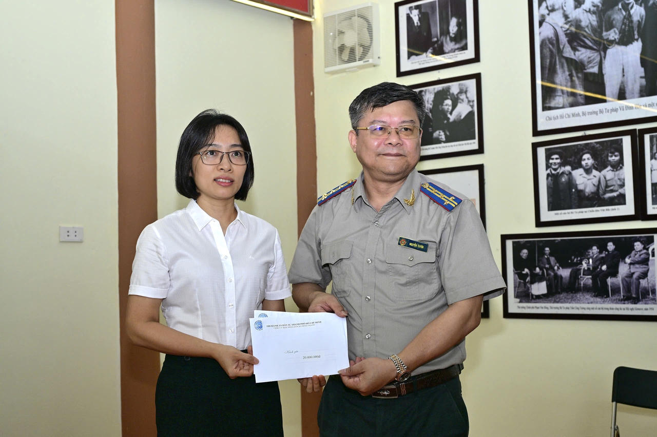 Trưởng THADS tỉnh Tuyên Quang đại diện tặng quà của THADS tỉnh Tuyên Quang và THADS TP Hồ Chí Minh cho đại diện UBND xã &nbsp;Minh Thanh. (Ảnh: Lê Hanh)