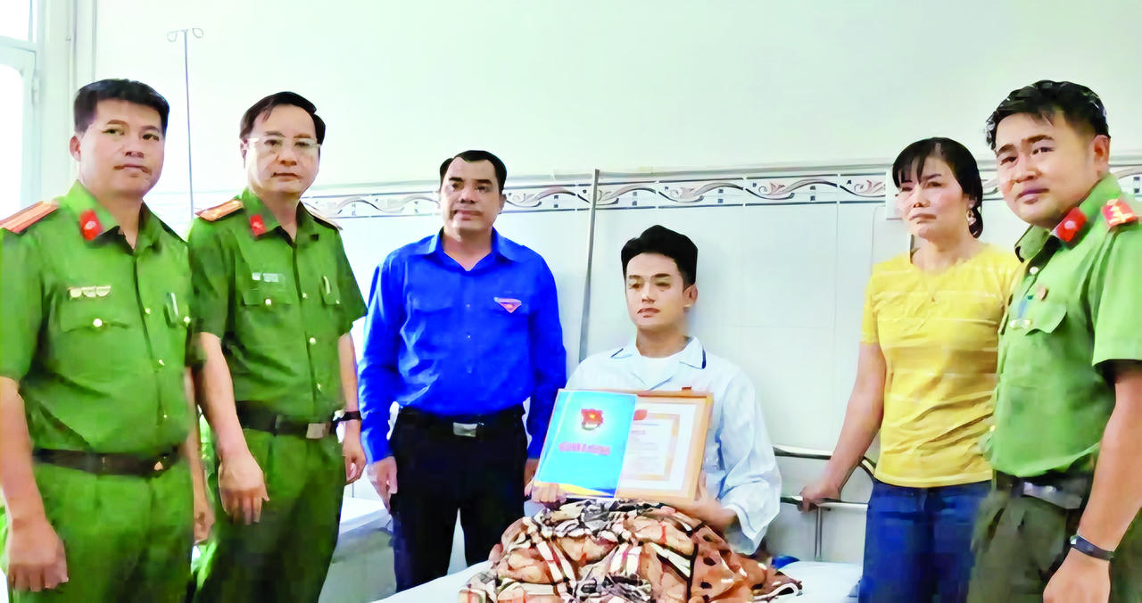 Đại diện Tỉnh đoàn Đồng Nai thăm, thừa ủy quyền của Trung ương Đoàn TNCS Hồ Chí Minh trao Huy hiệu Tuổi trẻ dũng cảm và Bằng khen của Tỉnh đoàn cho chiến sĩ Phan Đức Mạnh. (Ảnh: Huỳnh Phúc)