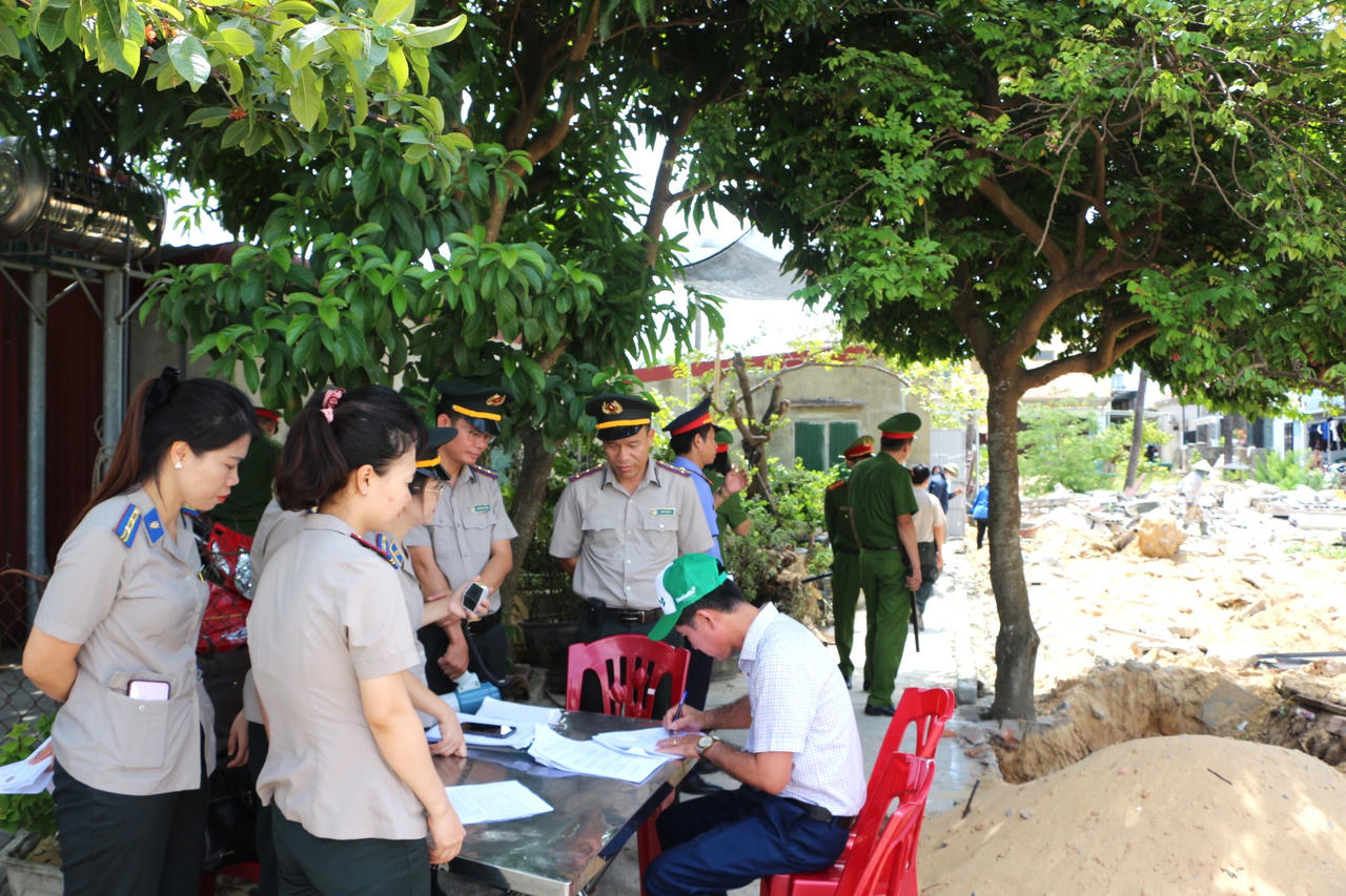 Các bên thực hiện ký biên bản bàn giao tài sản sau khi hoàn tất việc cưỡng chế thi hành án. (Ảnh M.P).