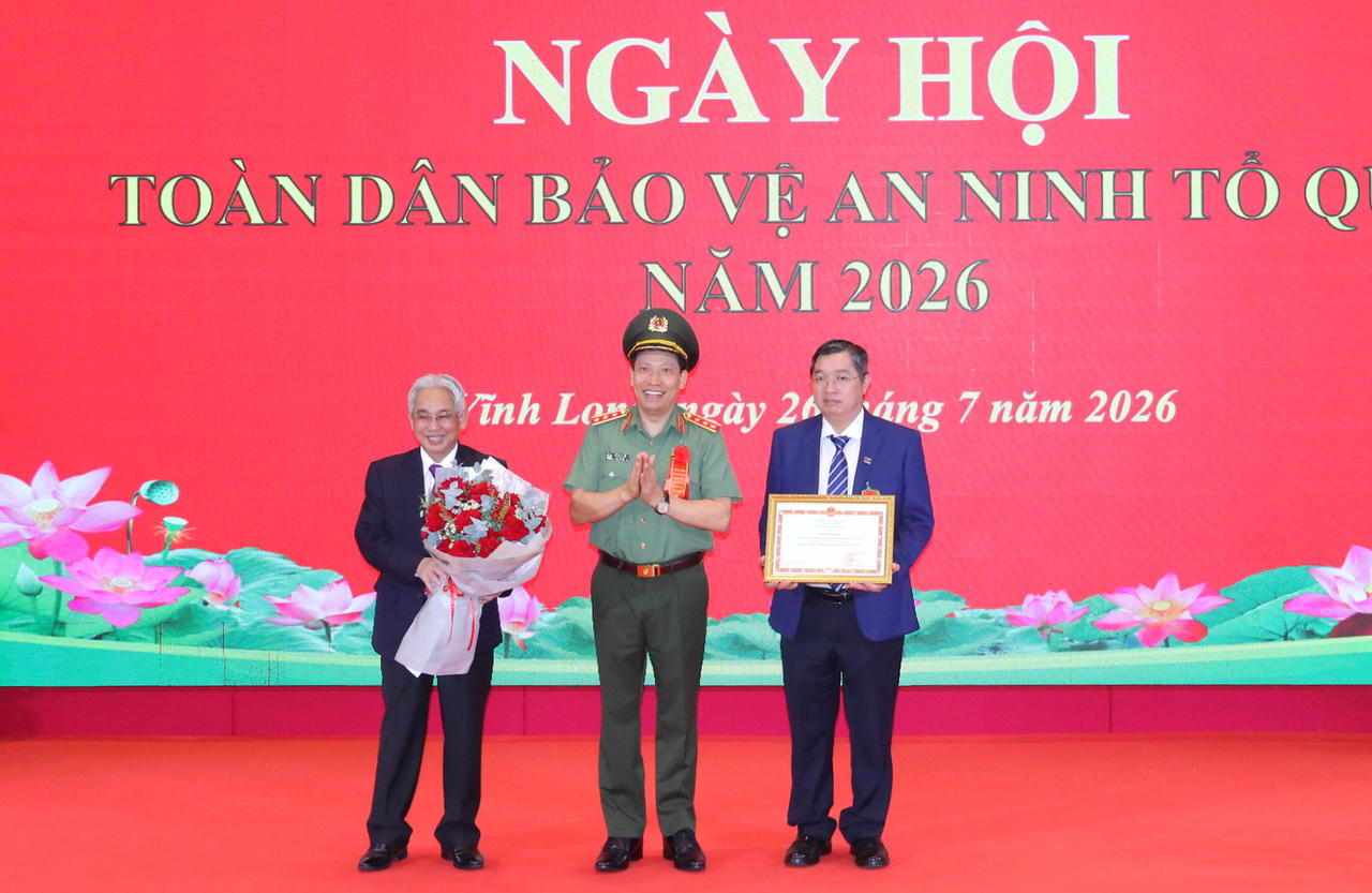 Thượng tướng Lê Văn Tuyến - Thứ trưởng Bộ Công an (giữa) trao Bằng khen của Bộ Công an cho Trường Đại học Cửu Long (Ảnh: Đình Thương)