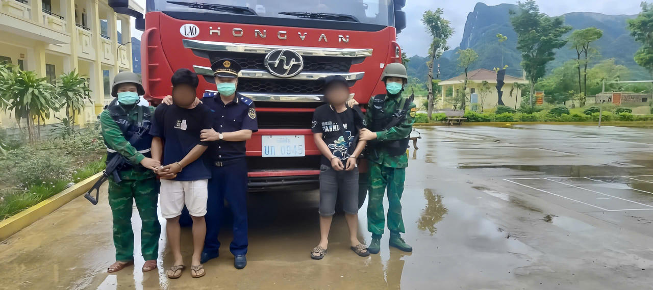 Hai đối tượng người Lào bị lực lượng Bộ đội Biên phòng tỉnh Quảng Trị và các đơn vị chức năng bắt giữ cùng xe đầu kéo dùng để vận chuyển trái phép 633kg pháo hoa nổ từ Lào vào Việt Nam. (Ảnh Hoài Nam).