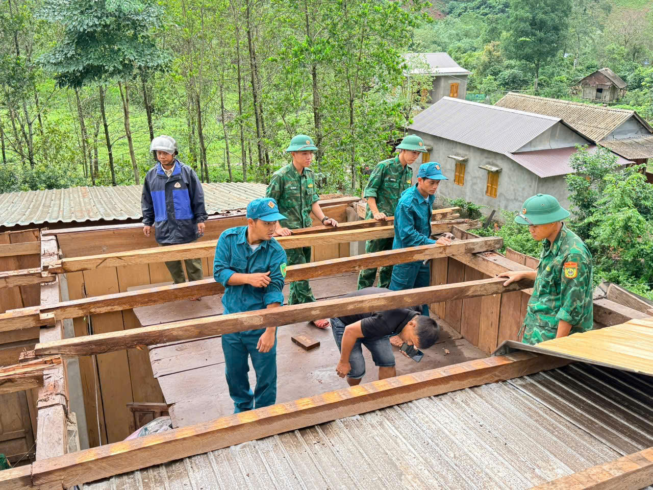 Lực lượng Biên phòng phối hợp với các lực lượng và người dân gia cố, sửa chữa mái nhà sau dông lốc. (Ảnh: Hoài Nam)