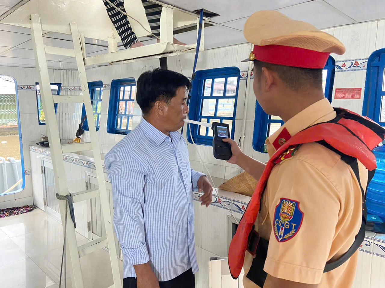 Cán bộ Trạm Cảnh sát đường thủy Ninh Quới kiểm tra nồng độ cồn và việc sử dụng chất ma túy đối với người điều khiển phương tiện (Ảnh: T.N).