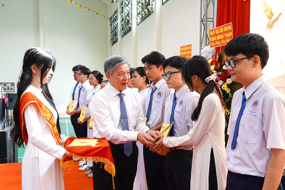 Ông Ngô Chí Cường - Bí thư Tỉnh ủy Đồng Tháp trao học bổng cho học sinh có hoàn cảnh khó khăn vươn lên trong học tập tại trường THPT Nguyễn Đình Chiểu. Nguồn ảnh: dongthap.gov.vn