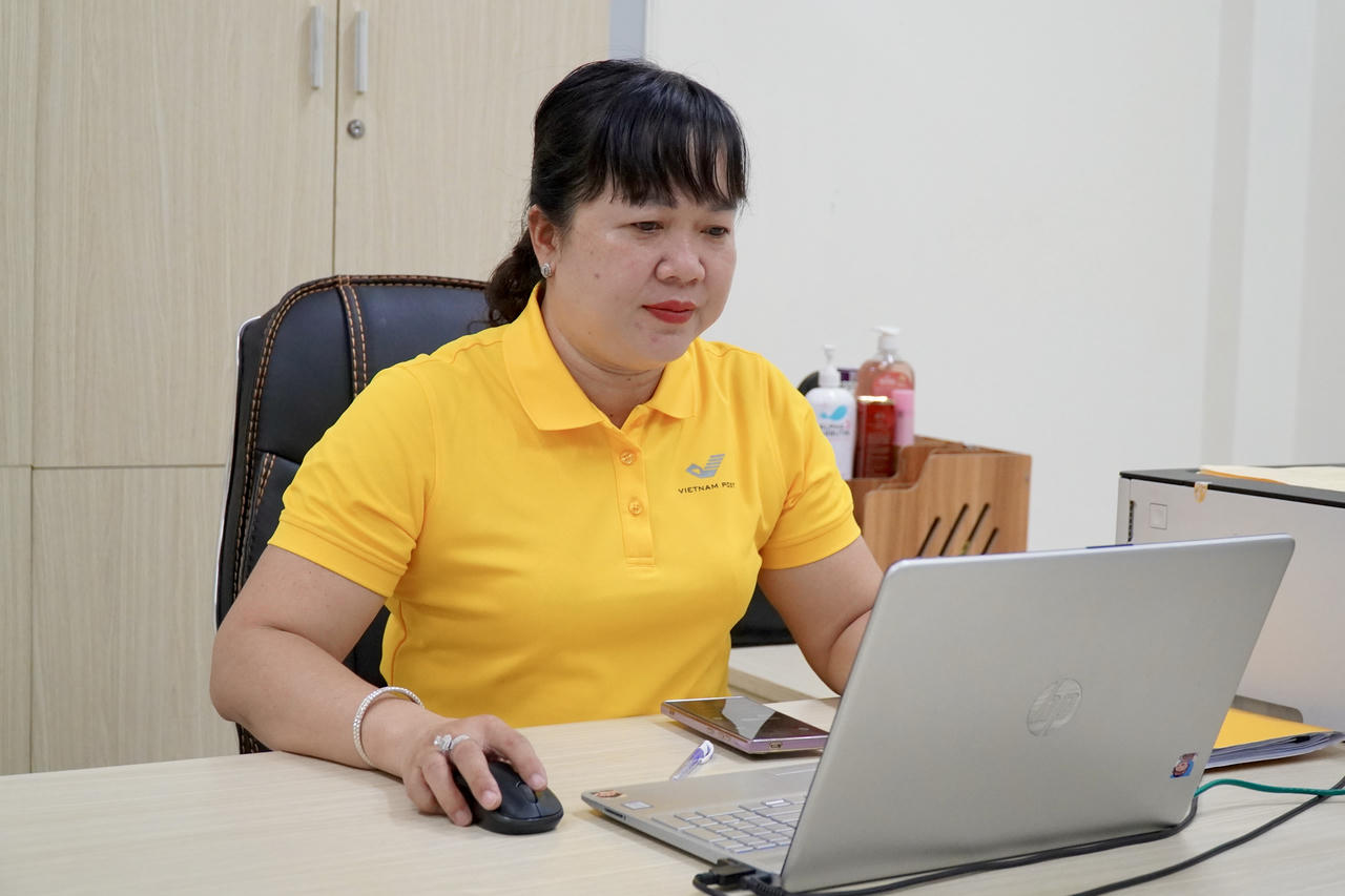 Bà Linh bắt đầu ngày làm việc với những phần việc với vai trò Giám đốc Bưu điện xã Bình Phú . Ảnh: Kim Ngân