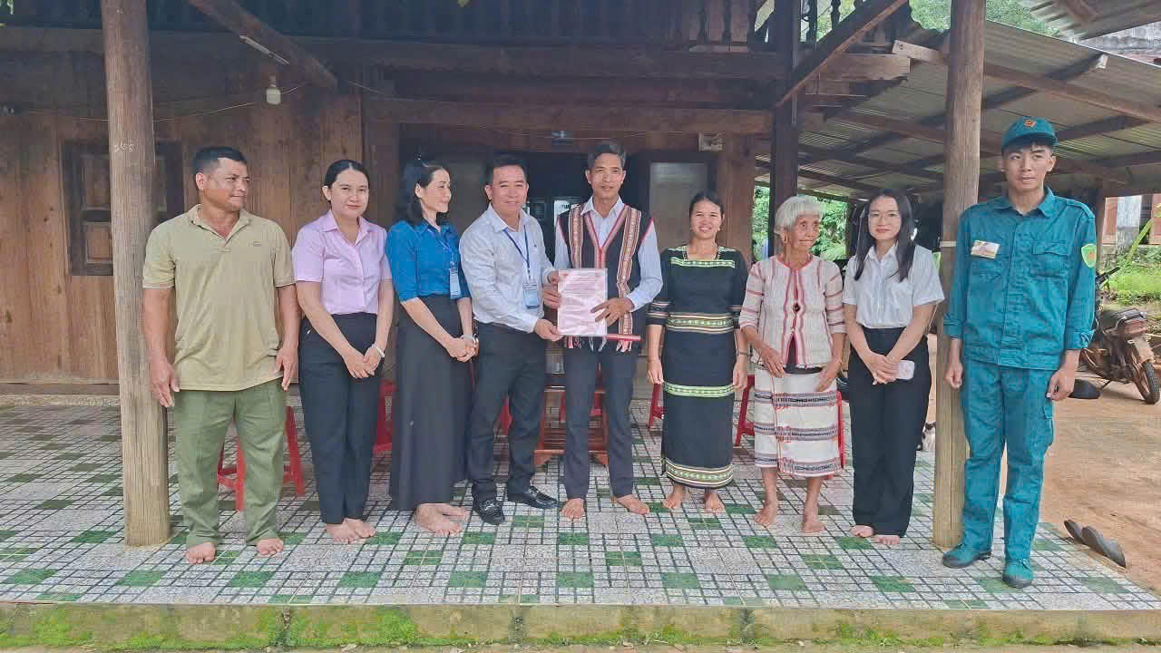 Cán bộ xã Bù Đăng đến tận nhà trao sổ đỏ cho người dân. Ảnh: Tiến Dũng.
