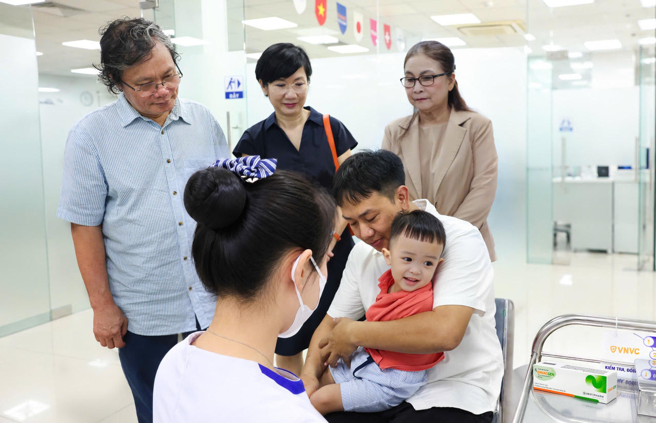 Bác sĩ Trương Hữu Khanh, người có hàng chục năm gắn bó công tác điều trị các ca tay chân miệng nặng tại Việt Nam chứng kiến mũi vắc xin phòng EV71 đầu tiên được tiêm cho trẻ tại VNVC. Ảnh: Nhân Lê