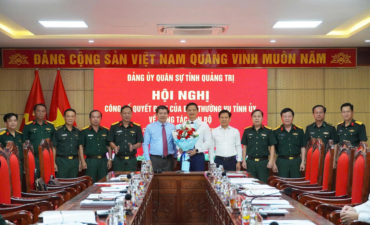Các đồng chí trong Ban Thường vụ Đảng ủy Quân sự tỉnh, thủ trưởng Bộ CHQS tỉnh và đại biểu tặng hoa, chụp ảnh lưu niệm với ông Vương Quốc Tuấn, Bí thư Đảng ủy Quân sự tỉnh. (Ảnh: Xuân Diện)