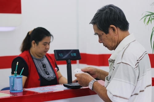 Một cụ già mua vé số tại điểm bán hàng trên đường Dương Bá Trạc (quận 8).