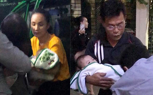 Ông Nam (phải) bế đứa trẻ xuống taxi. Ảnh cắt từ clip