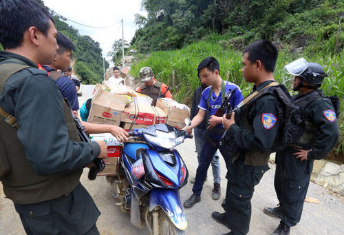 Cảnh sát kiểm tra hàng hoá của người dân trong bản. Ảnh: Bá Đô