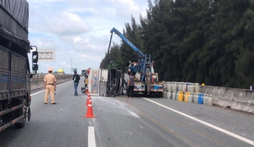 Xe tải chở gas lật ngang, hàng trăm bình gas đổ tràn xuống đường